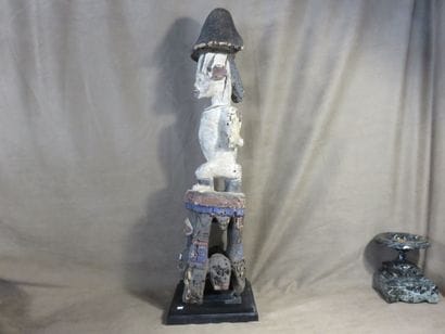 Male statue. The figure is depicted sitting...