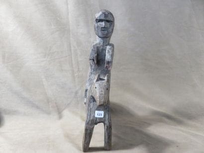Statue of a man on horseback. Wood with grey...