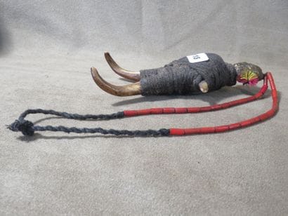 Necklace representing a character, the head...