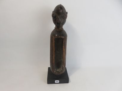 Small slotted drum used by diviners. It is...