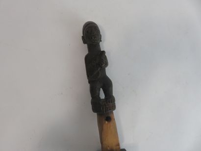 Fetish represented standing carrying a rifle...