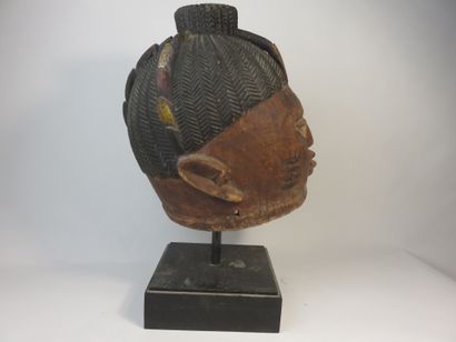 Ancient Gelede helmet mask. The face is decorated...