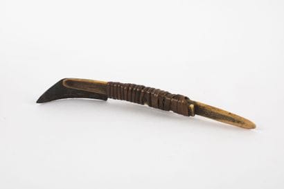 Curved knife with an iron blade mounted on...
