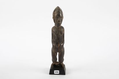 Male ancestor standing with both hands on...