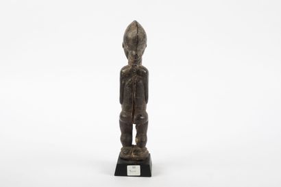 Male ancestor standing with both hands on...