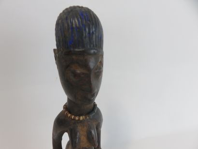 Ibedji. Female statuette, the body is realistic....