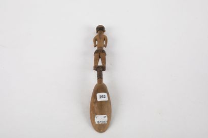 Spoon representing a woman standing with...