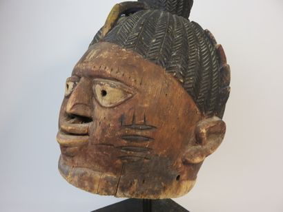 Ancient Gelede helmet mask. The face is decorated...
