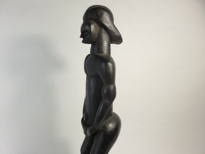 Pole top representing a male Byeri. He is...