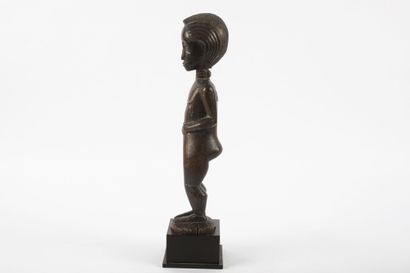 Male ancestor standing with both hands on...