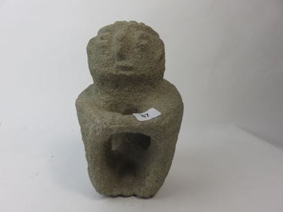 Sukia. Seated figure, both hands resting...