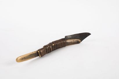 Curved knife with an iron blade mounted on...