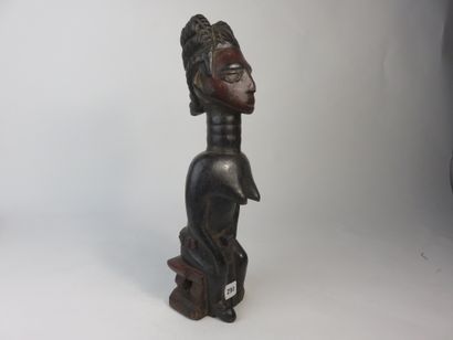 Female fetish represented sitting on a stool,...