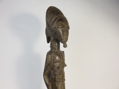Male ancestor standing with both hands on...