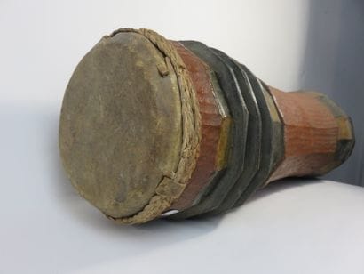 Curved cylinder drum on legs. Polychrome...