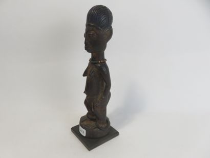 Ibedji. Female statuette, the body is realistic....