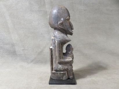Maternity seated on a high-backed throne,...