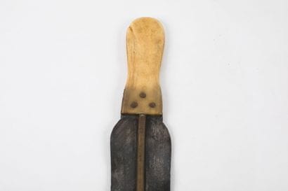 Knife made of a thin steel blade with bronze...