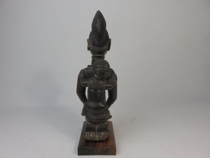 Motherhood represented kneeling, she holds...