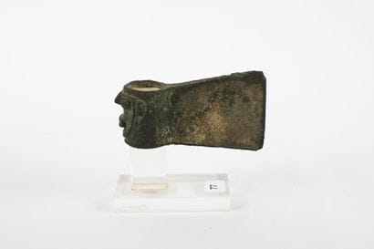 Axe with heel decorated with a human head....