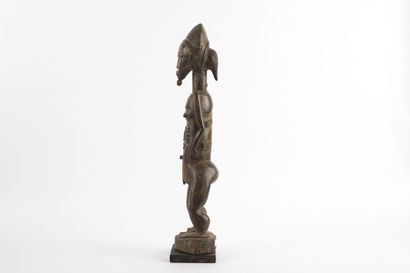Male ancestor standing with both hands on...