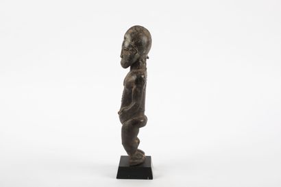 Male ancestor standing with both hands on...