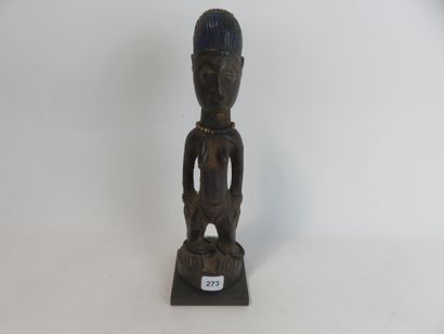 Ibedji. Female statuette, the body is realistic....