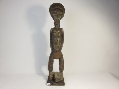 Male ancestor standing with both hands on...