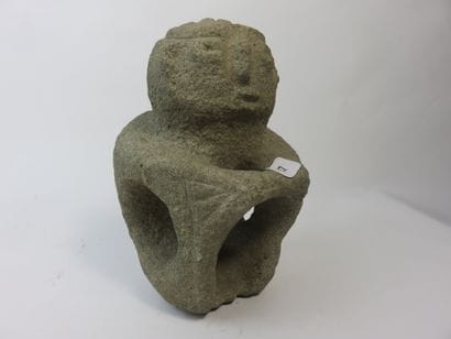 Sukia. Seated figure, both hands resting...
