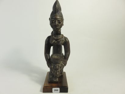 Motherhood represented kneeling, she holds...