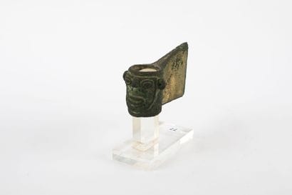 Axe with heel decorated with a human head....