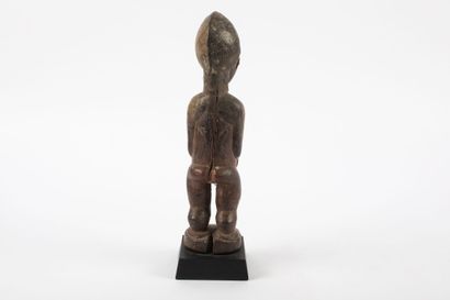 Male ancestor standing with both hands on...