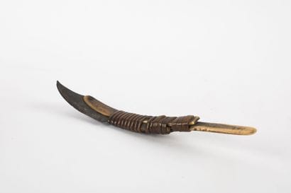 Curved knife with an iron blade mounted on...