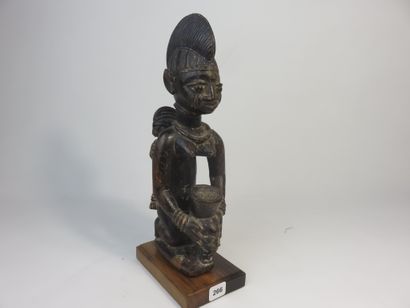 Motherhood represented kneeling, she holds...