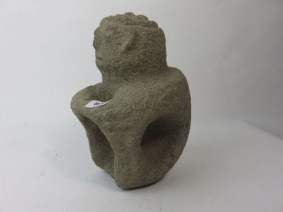 Sukia. Seated figure, both hands resting...
