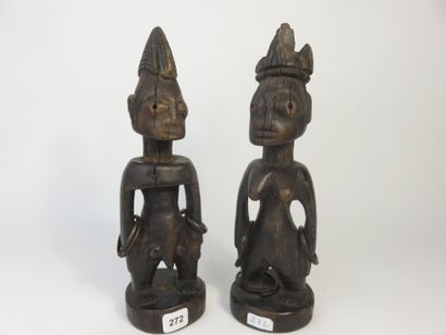 Pair of ibedji. Two statuettes, one male,...