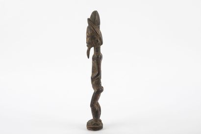 Male ancestor standing with both hands on...