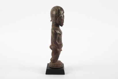 Male ancestor standing with both hands on...