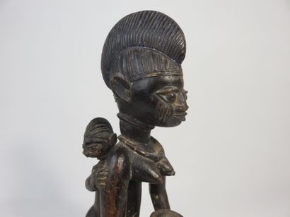 Motherhood represented kneeling, she holds...