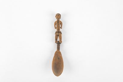 Spoon representing a woman standing with...