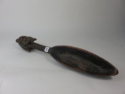 Spoon. The handle, fluted, is surmounted...
