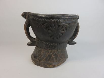 Heavy wooden mortar with a patina of use....