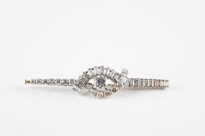 A white gold and platinum brooch with a moving...