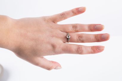 Solitaire ring set with a cushion-cut diamond...