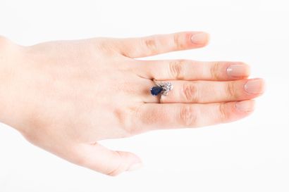 White gold ring set with a pear-cut sapphire...