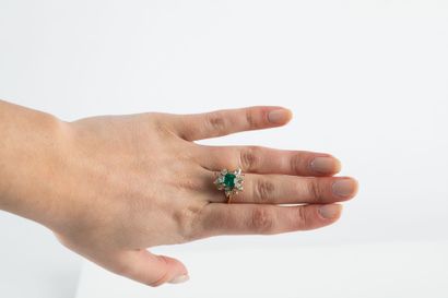 Yellow gold floral ring set with a cut emerald...