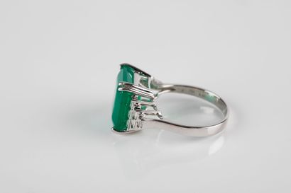 White gold ring set with a large emerald...