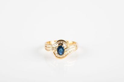 Yellow gold ring centered on an oval sapphire...
