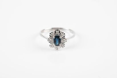 White gold ring set with an oval sapphire...