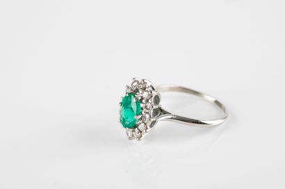 White gold daisy ring set with an oval emerald...